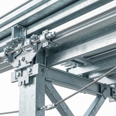 Close-up of cable support system in an industrial setting, showing various materials
